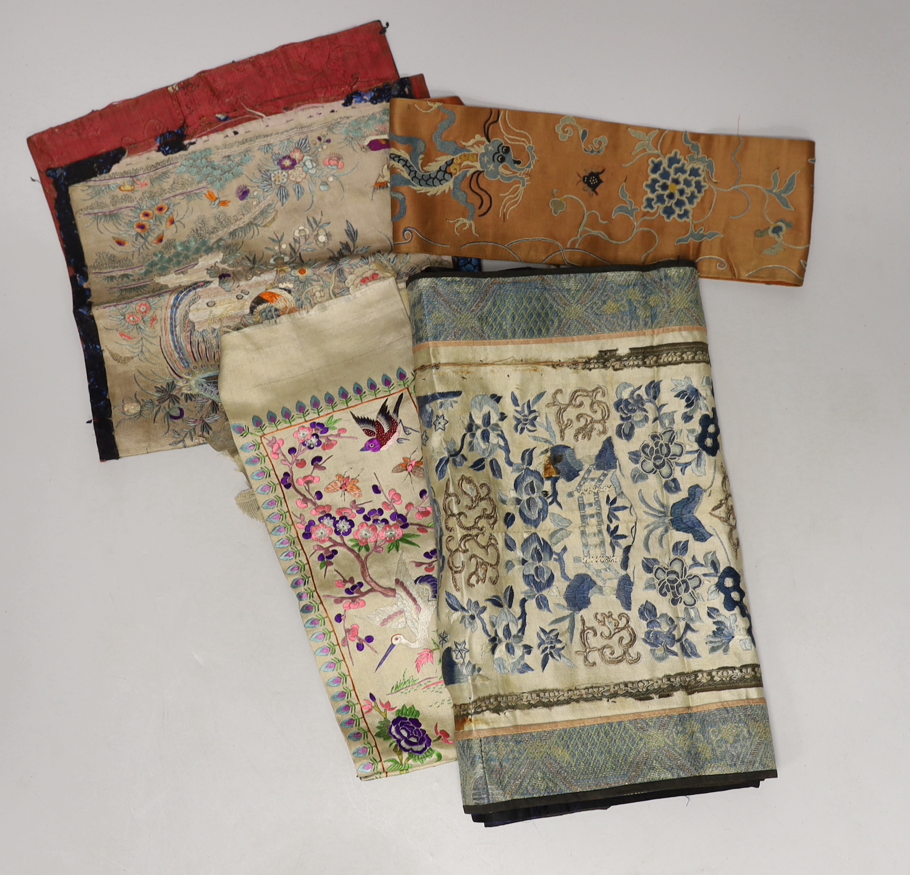 Three late 19th century Chinese silk embroidered panels, possibly made from sleeve bands, together with another pair of later embroidered sleeve bands and three other embroideries